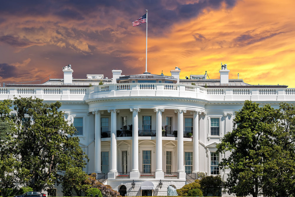 The American flag flaps atop the White House in Washington, DC