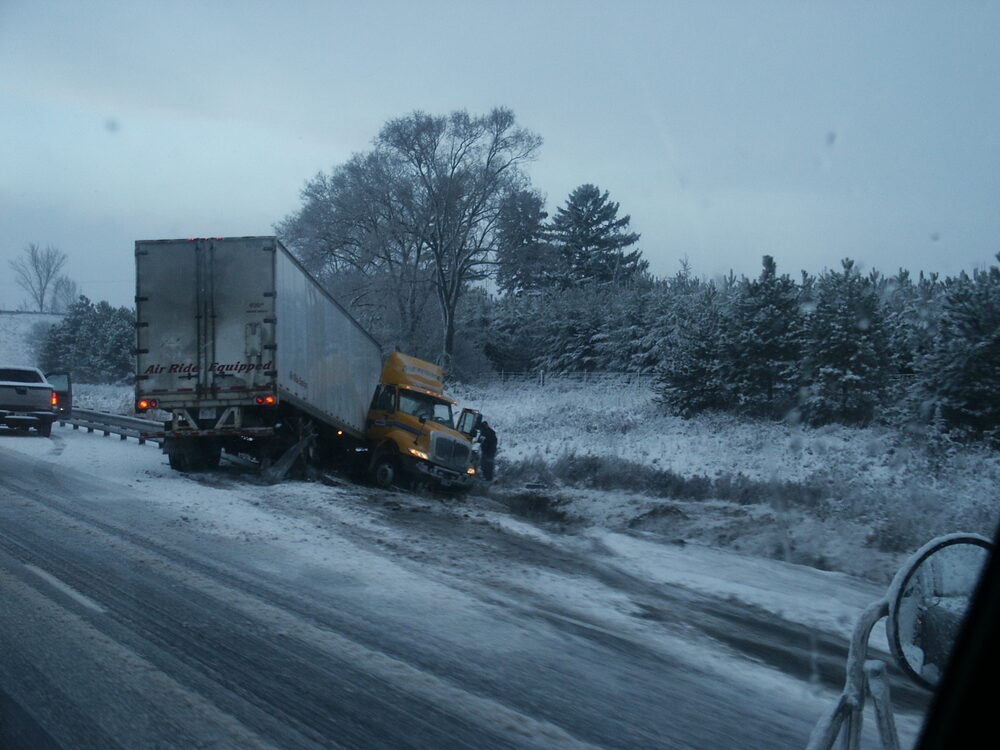 Tractor-Trailer Crash on NJ Turnpike Near Exit 6 In Burlington County Involving Multiple Tractor-Trailer, Including Lidl Truck disabled truck on the side of highway after accident on a winter day