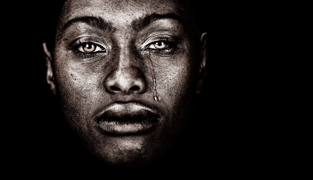 Image Of an afro American woman Crying isolated on Black.