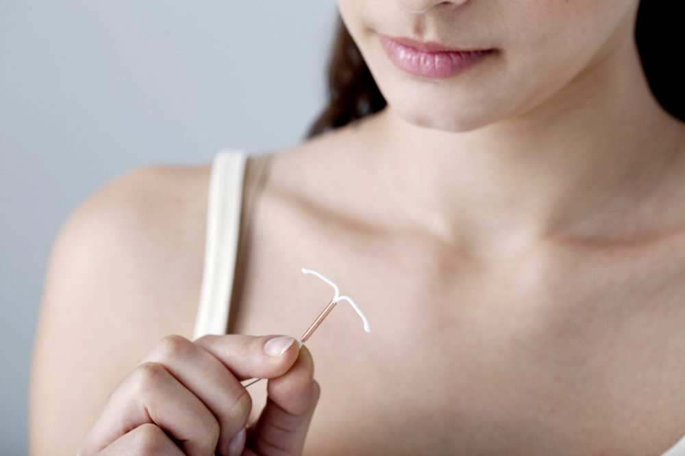 woman holding an iud