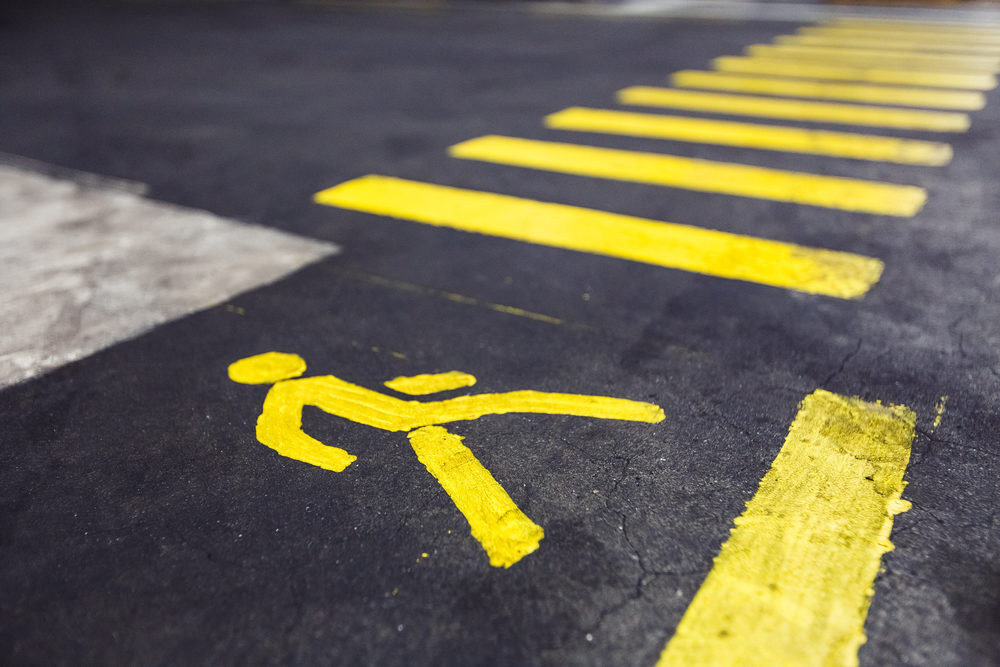 Hit-and-Run Leaves Pedestrian Dead, Driver Injured in San Jose yellow pedestrian crossing marked on asphalt closeup