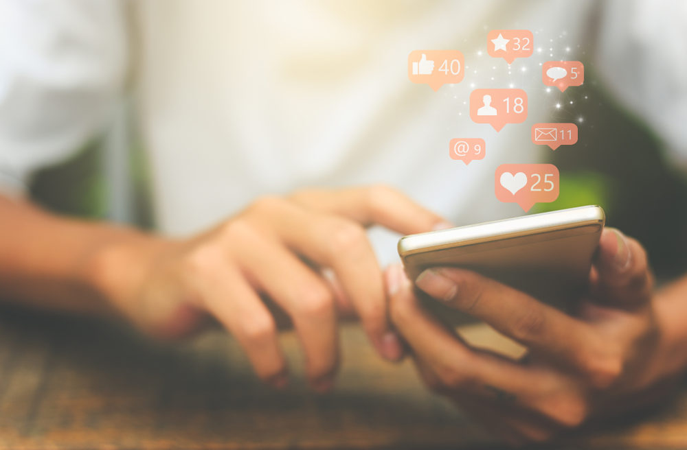 closeup of young male holding his smartphone to check social media