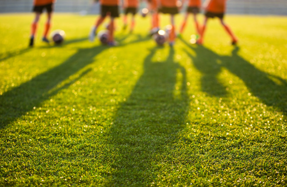 Snoqualmie Youth Soccer Coach, Joshua Lewis, Arrested for Alleged Inappropriate Messages to Minor blurred view of young soccer players on a field