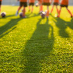 blurred view of young soccer players on a field