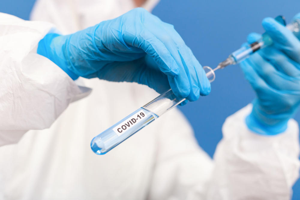 Scientist in the laboratory with test tube and virus.