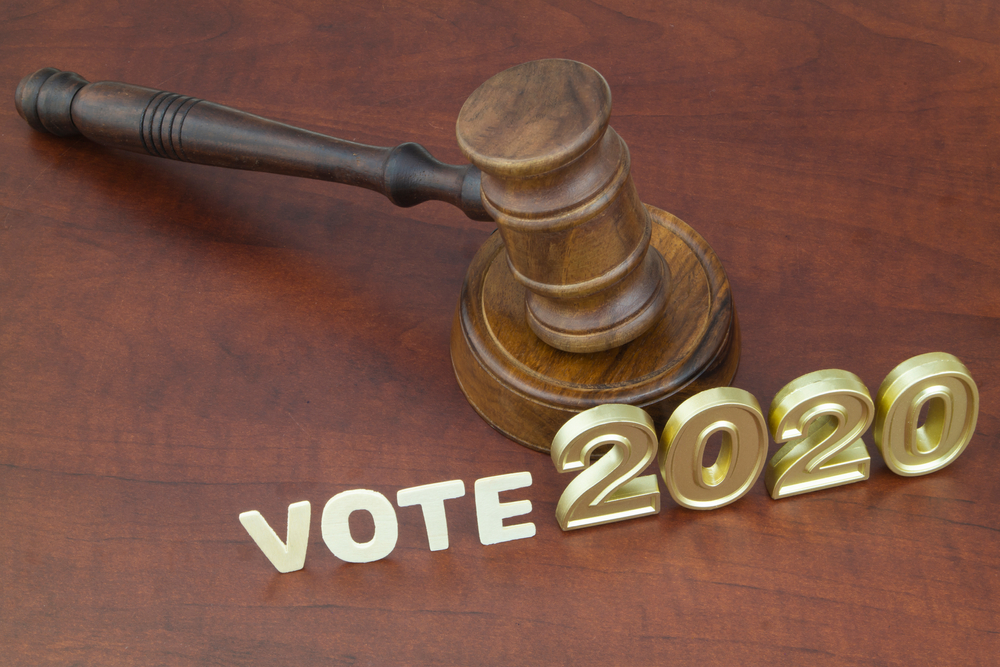 Wooden judge gavel, letters vote and numbers 2020