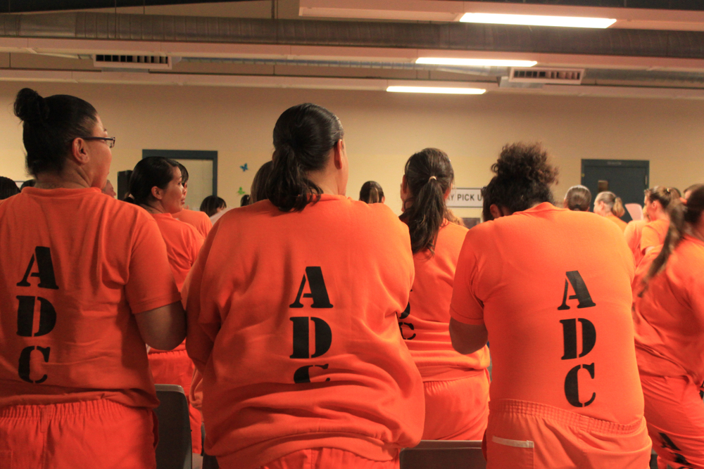 Perryville State Prison inmates listen as Olympic gold medalist Misty Hyman speaks about making a fresh start in life after their release from prison.