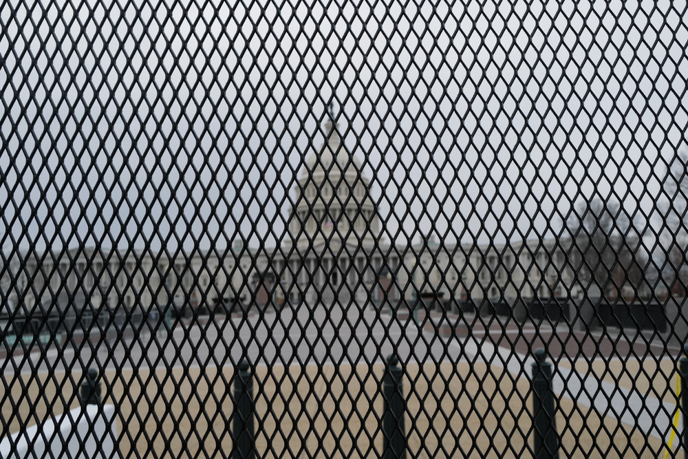 A view of the U.S. Capitol through the recently installed security barrier in the aftermath of the storming if the building by Trump supporters.