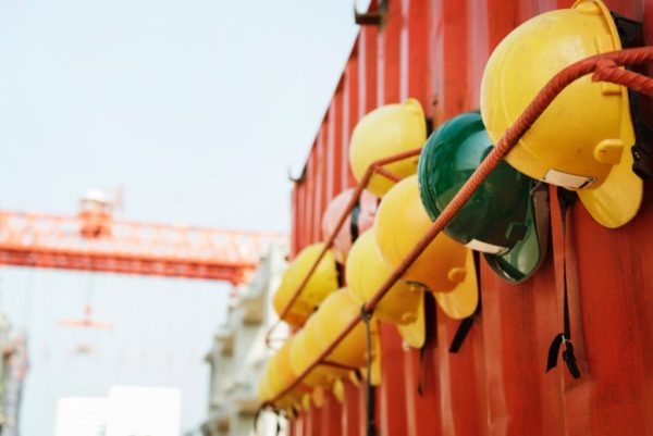 A rack of yellow safety helmets at a construction work site