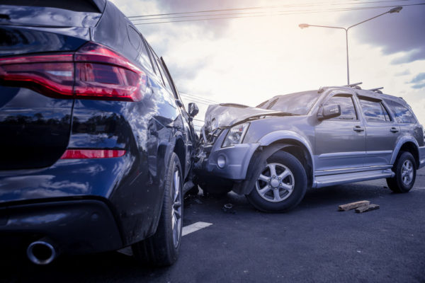 Two passenger vehicles with extensive damage after a wreck