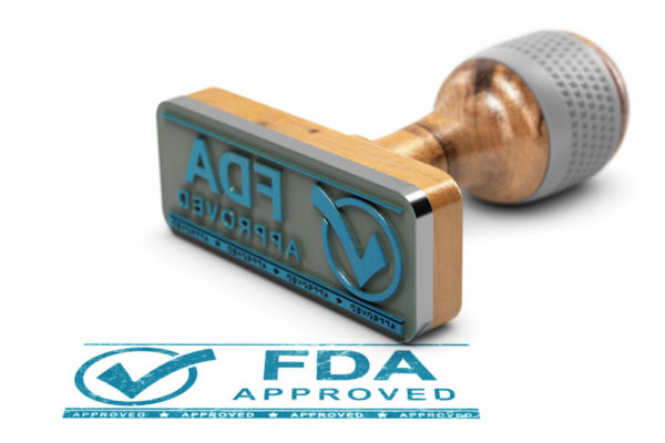 A blue ink stamp with the words "FDA APPROVED" and a checkmark