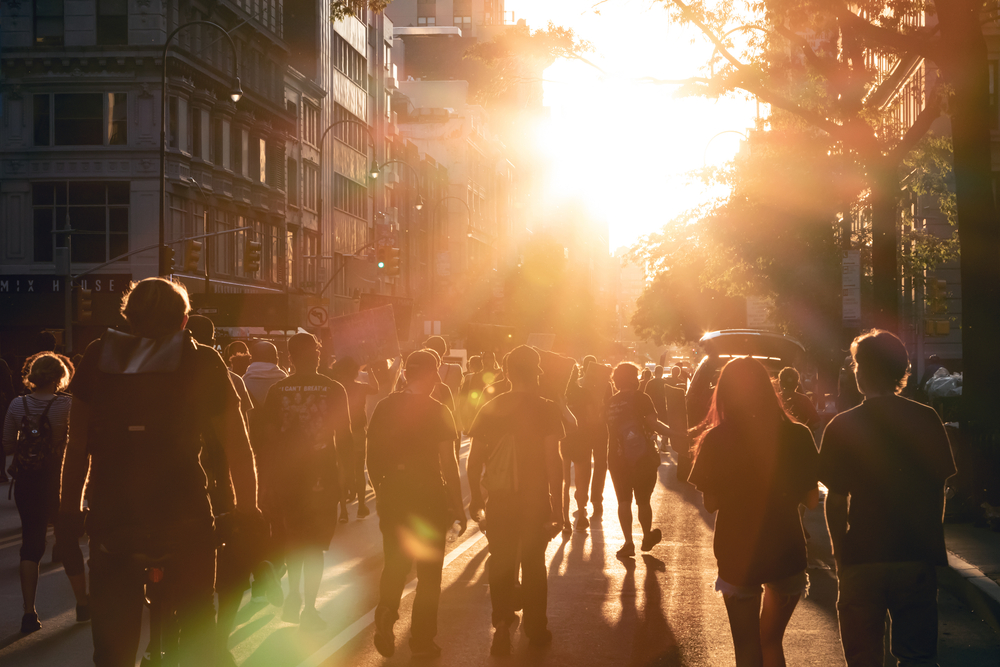 NEW YORK CITY, USA - JUNE 12, 2020: Crowd of people walk into the light of sunset at a peaceful Black Lives Matter protest march on 14th Street in Manhattan.