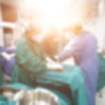 Abstract blur background of medical team is performing baby cesarean section in operating room at hospital.