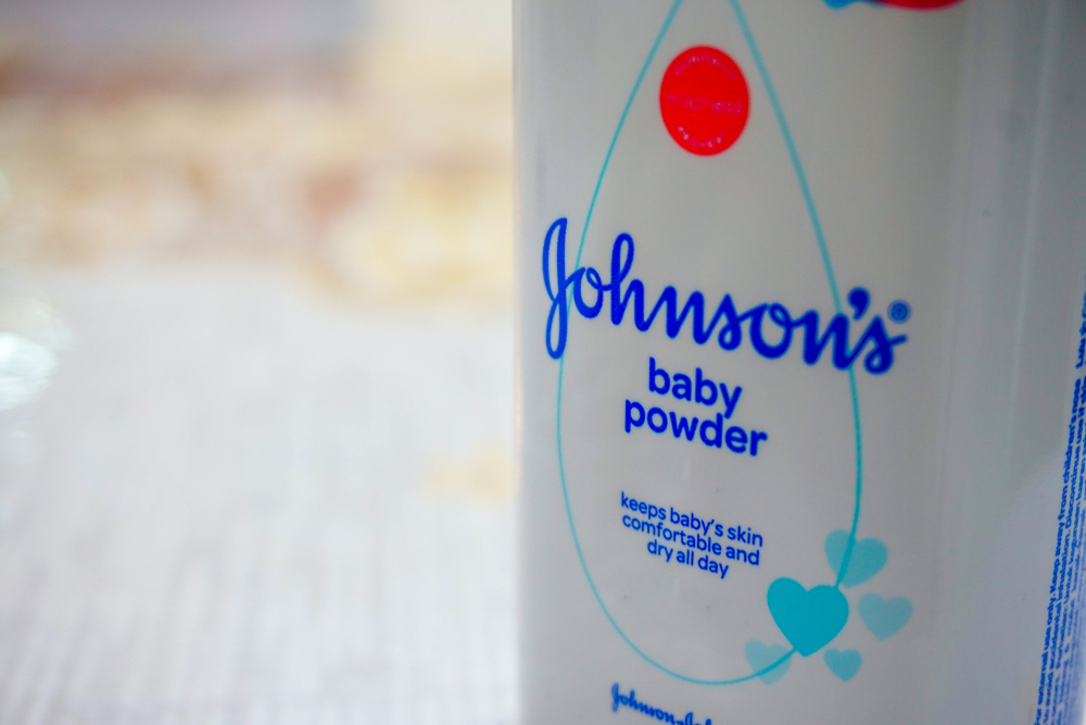 Close up image of white bottle of Johnson's baby powder isolated on table