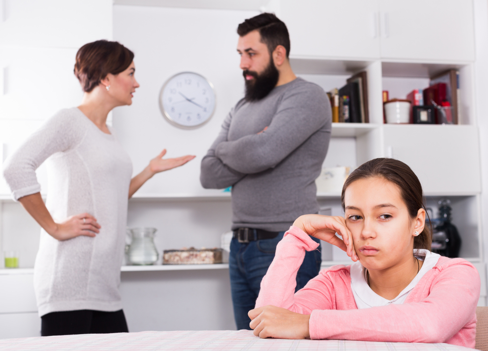 Father and mother having disagreement while their child at home