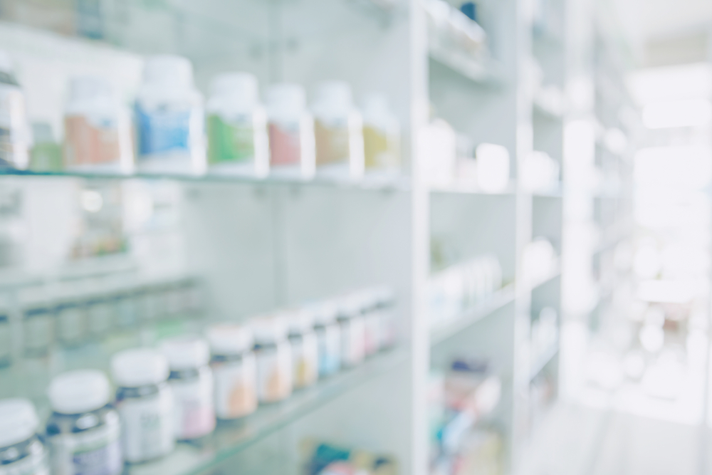 Pharmacy blurred light tone with store drugs shelves interior background