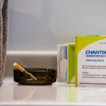 Chantix is a smoking cessation medicine. Here it is display with a tobacco cigarette in an ashtray.