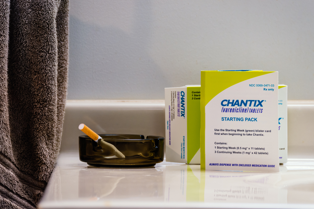 Chantix is a smoking cessation medicine. Here it is display with a tobacco cigarette in an ashtray.