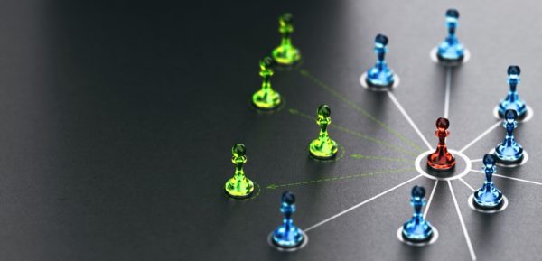 3D illustration of pawns linked together over black background.