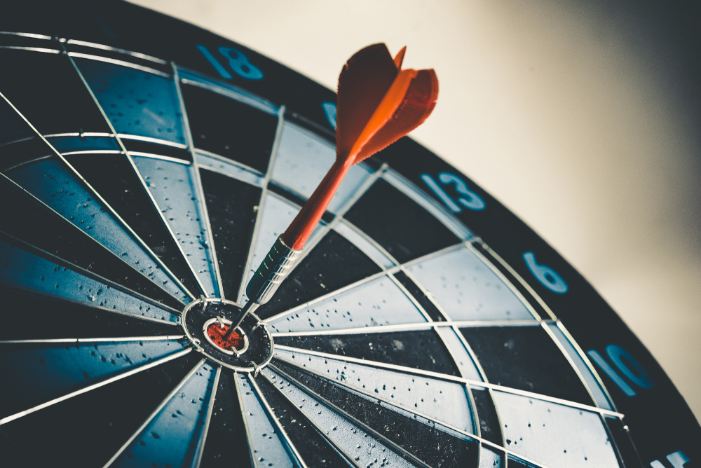 Close up shot of the dart arrow hit on bullseye of dartboard