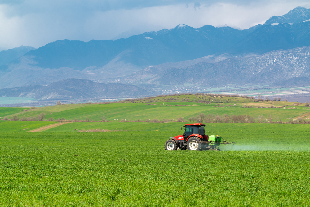 Paraquat Lawsuits: Parkinson’s Disease $Tractor sprays a farm field with pesticides