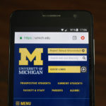 Official website of the University of Michigan displayed on a smartphone.