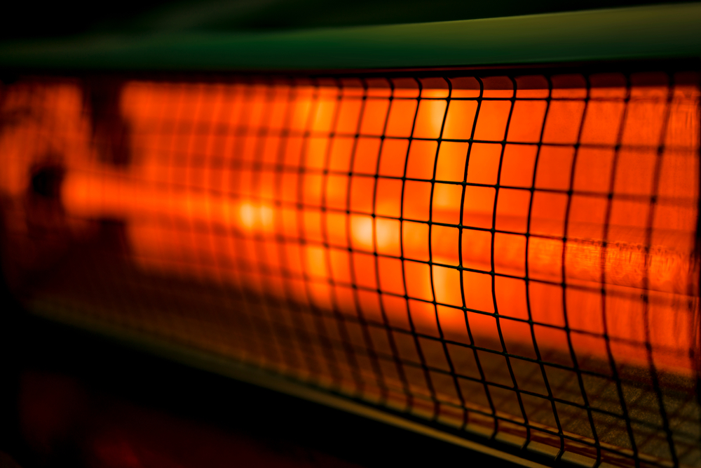 Close up of portable electric halogen heater on black background