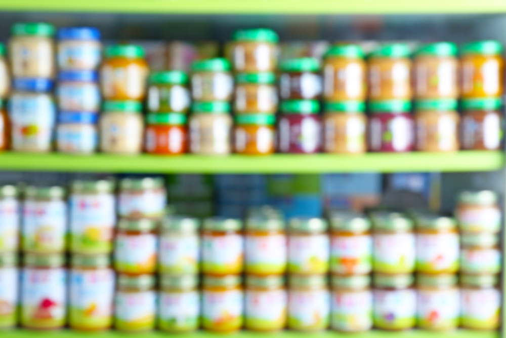 $Blurred view of shelves with baby food in store