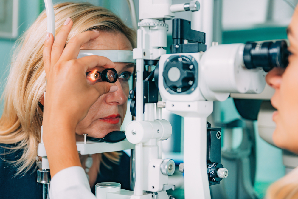 retinal exam of a female with magnifying glass