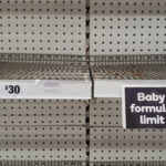 Empty baby formula shelves at a supermarket