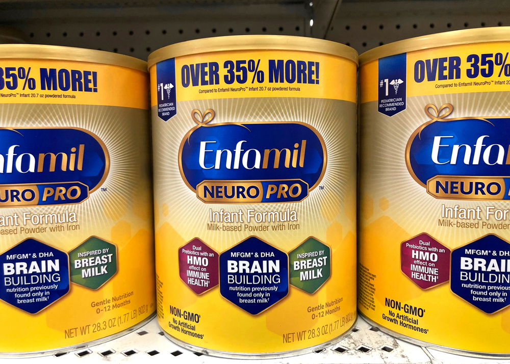 Grocery store shelf with canisters of Enfamil brand neuro pro baby formula.