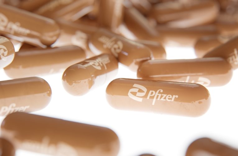 Close up photo of Pfizer's pills on a white backlight background