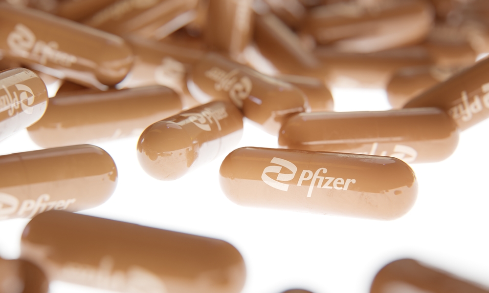 Close up photo of Pfizer's pills on a white backlight background