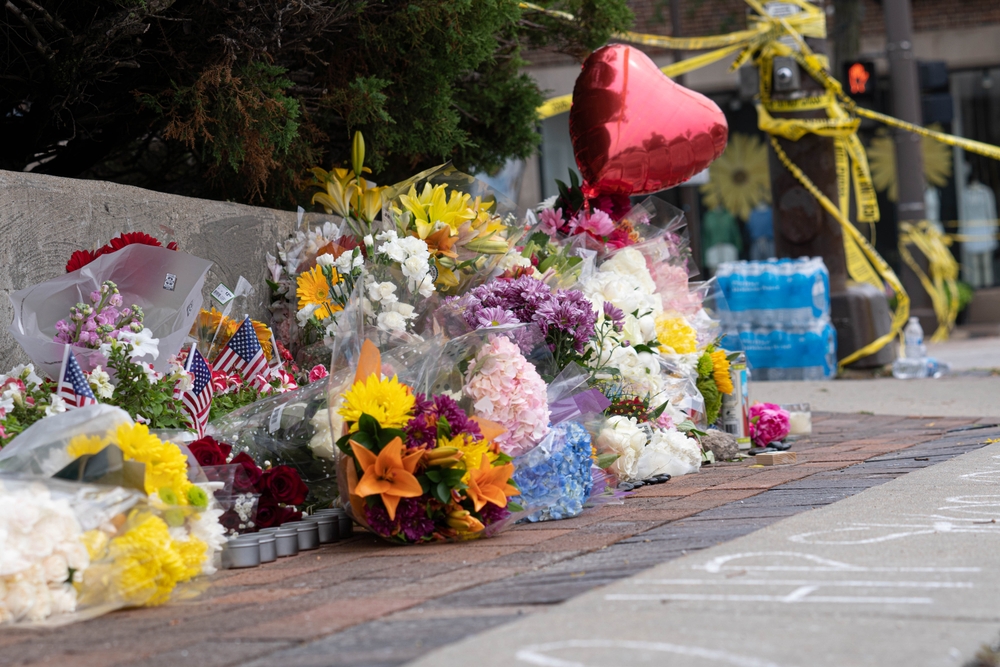 A memorial at Green Bay Road and Central Avenue in Highland Park grows for the seven people who were killed when a gunman opened fire at a parade.