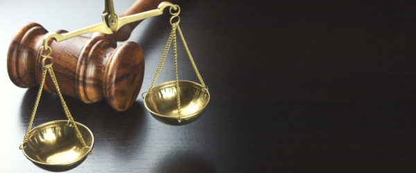 Judges Gavel And Scale Of Justice On The Black Table Background