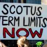 A demonstrator holding a sign reading "SCOTUS Term Limits" during a Bans off our Bodies rally following the Supreme Court ruling overturning Roe v. Wade.