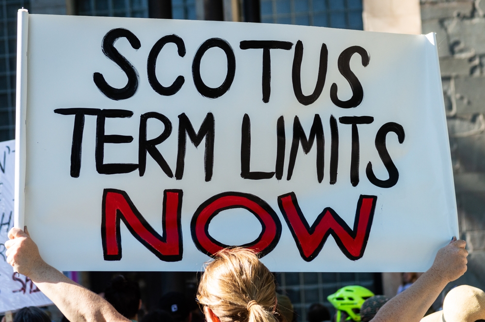 A demonstrator holding a sign reading 