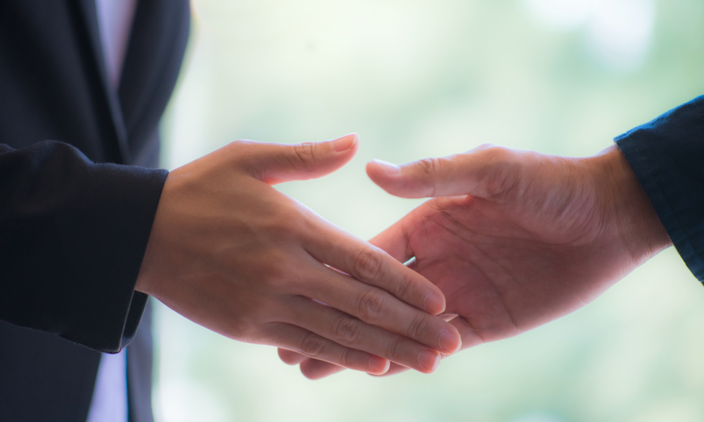 client and attorney shaking hands after a successful deal
