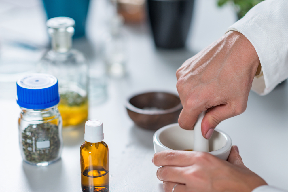 Homeopath preparing alternative herbal medicines.