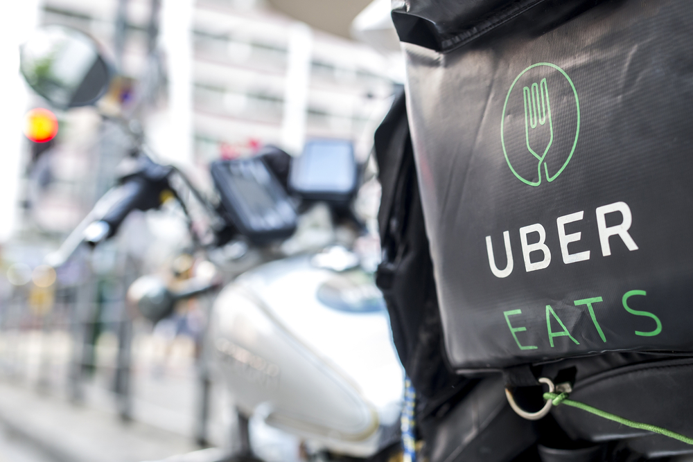 An Uber Eats driver's motorcycle parked on the side of the road