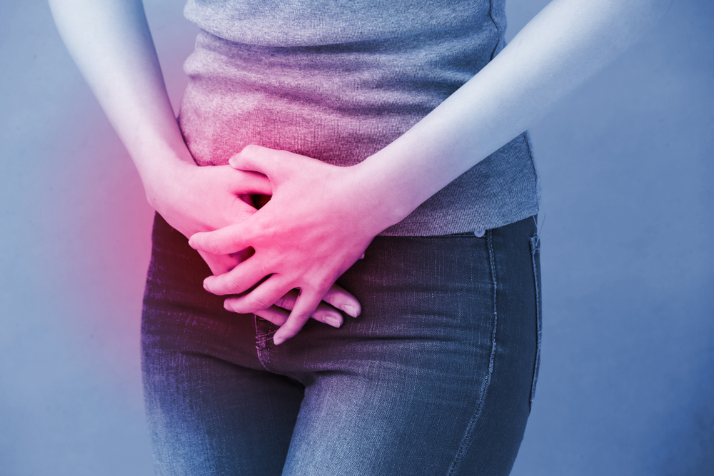 woman holding bladder with a blue background