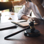 Lawyer is consoling distraught client in office