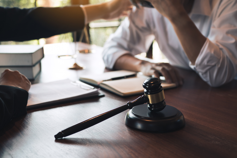 Lawyer is consoling distraught client in office