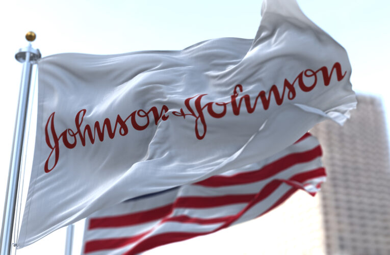 flag with the Johnson & Johnson logo waving in the wind with the American flag.