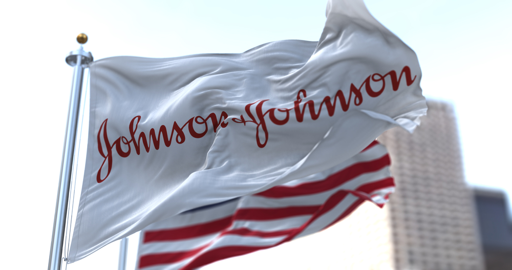 flag with the Johnson & Johnson logo waving in the wind with the American flag.