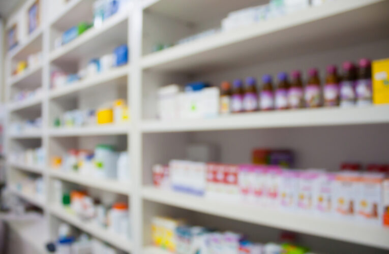 blurred pharmacy shelves with medicine stocked