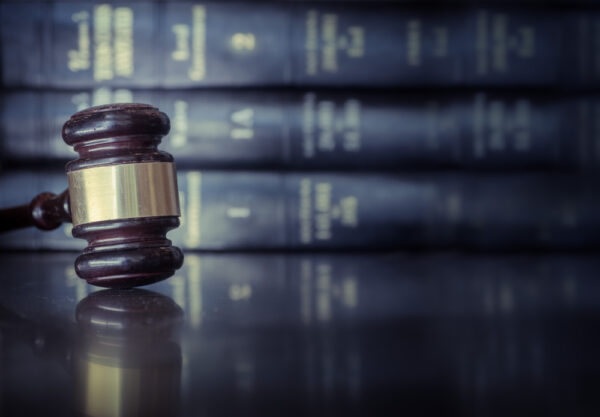 gavel on desk with law books behind