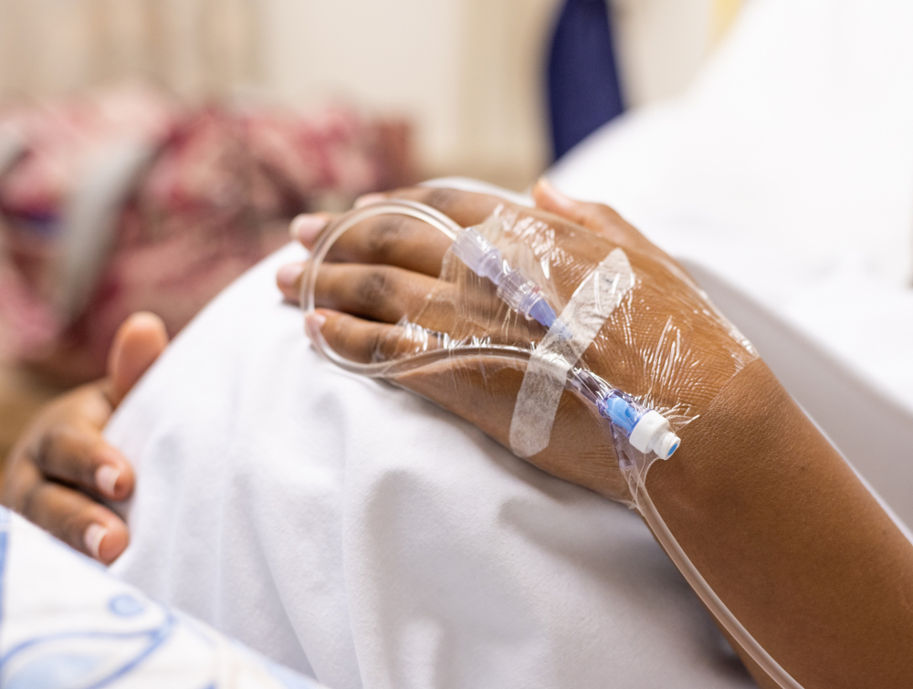 closeup of a pregnant woman's belly in a hospital bed