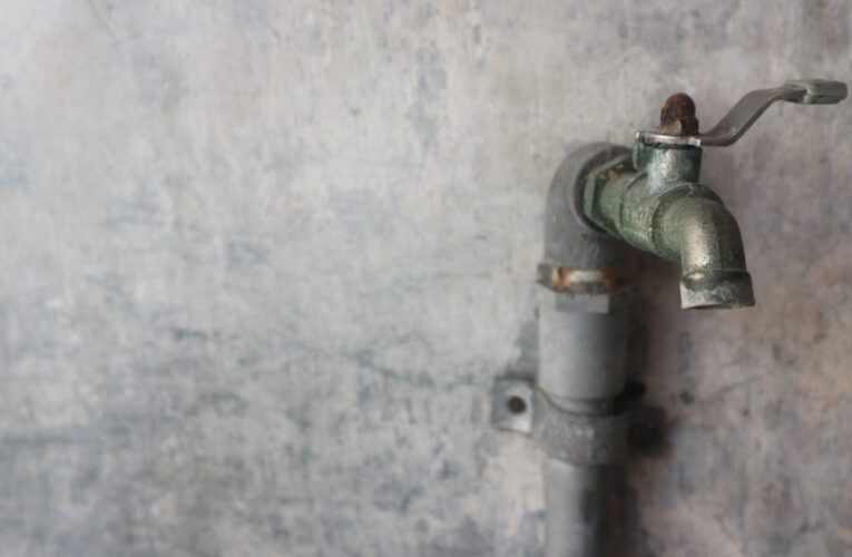 water faucet attached to a concrete wall