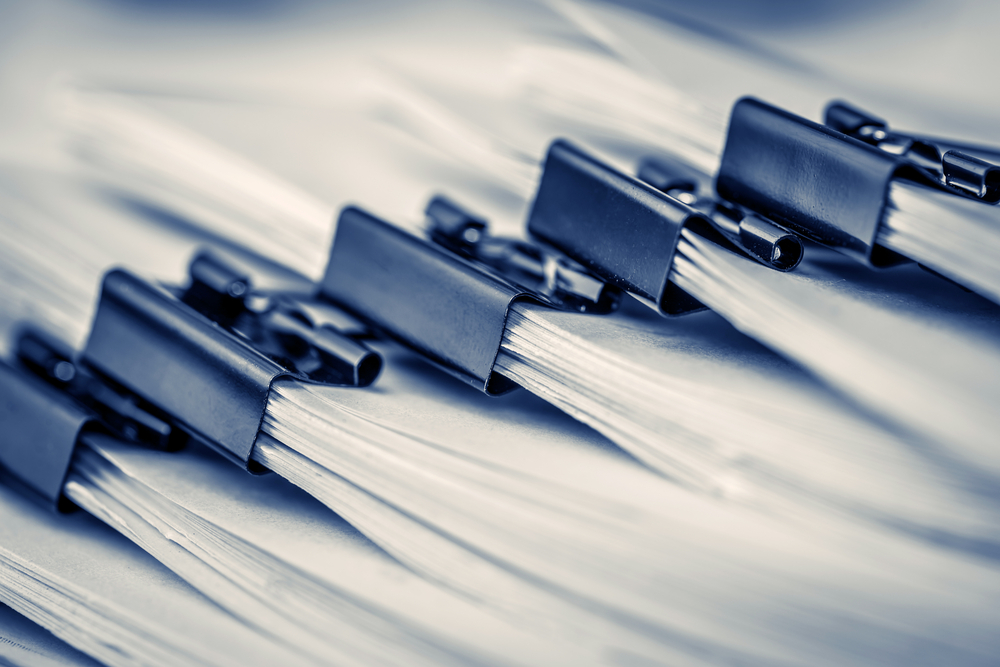 closeup of paper clipped stacks of documents